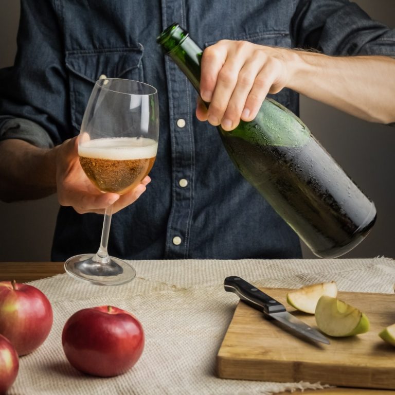 Pouring sparkling cider into a glass